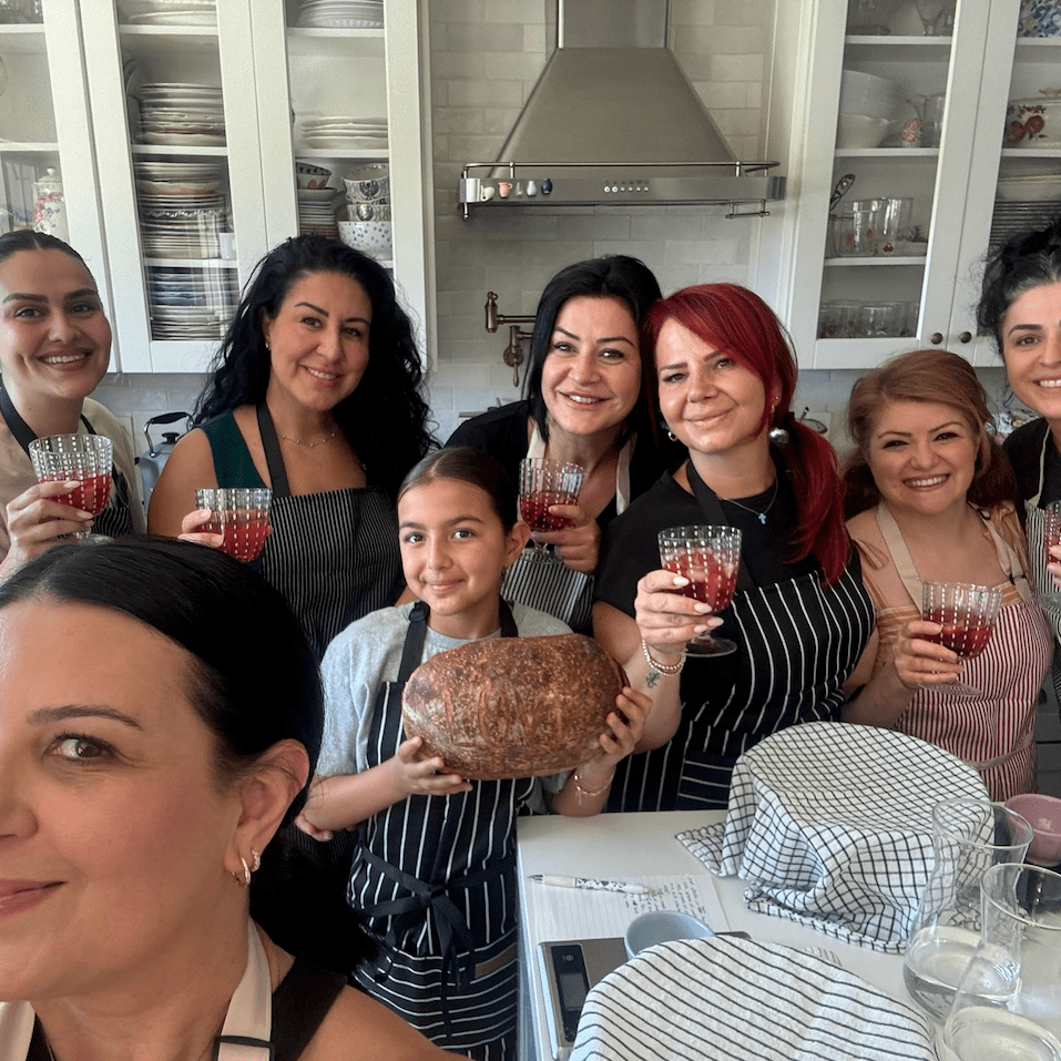 Overhead shot of a person preparing fresh dough on a wooden surface with rolling pin